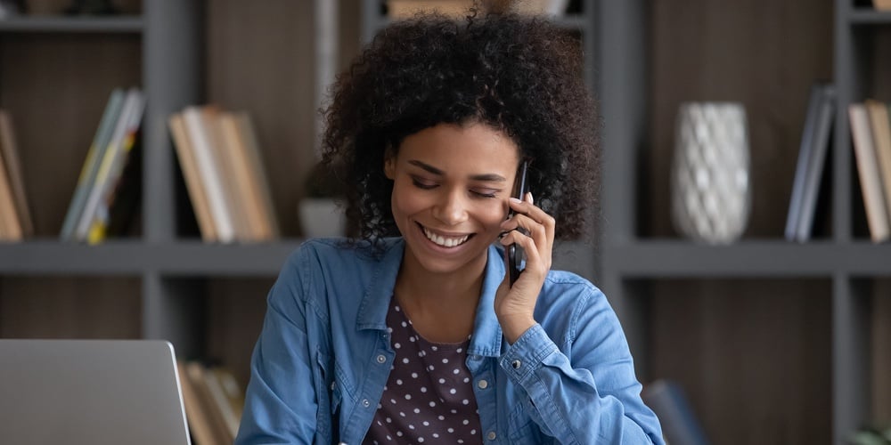 Happy Black Freelance Employee Speaking To Client On Mobile Phone