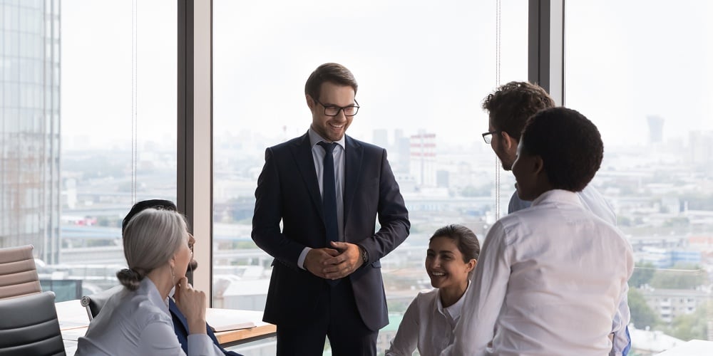 bigstock-Happy-Boss-Holding-Meeting-Wit-458242945