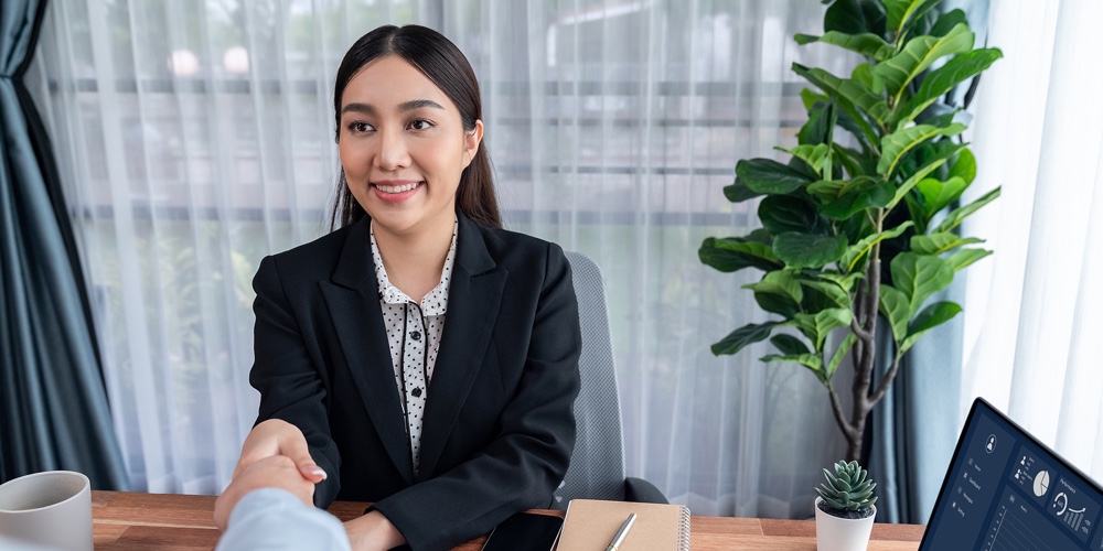 Happy Business People Shake Hands After Successful Meeting Or Job Interview With Resume. Hr Manager