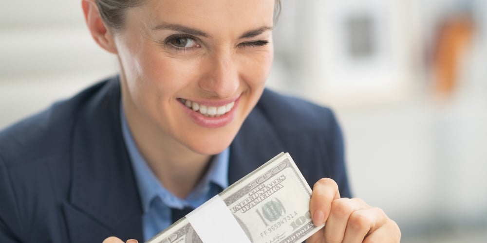 bigstock-Happy-Business-Woman-Money-Pac-62402015