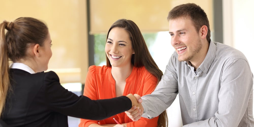 bigstock-Happy-Customers-Handshaking-Af-198216040