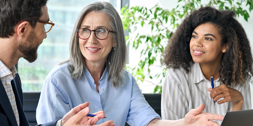 Happy Diverse Business People Group Negotiating Business Strategy At Boardroom Meeting Table Using L
