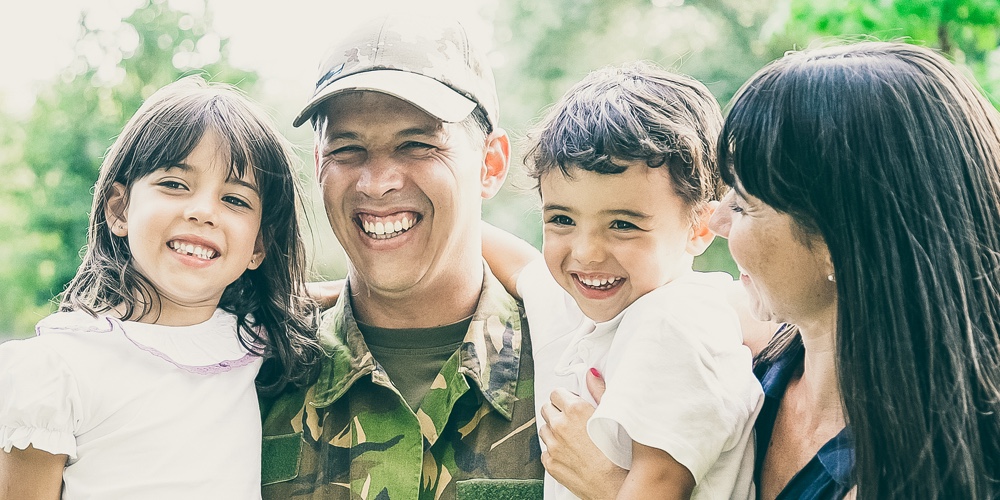 Happy Military Man Posing For Camera With His Family