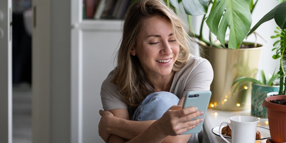 Happy Pleasant Woman Using Mobile Smart Phone