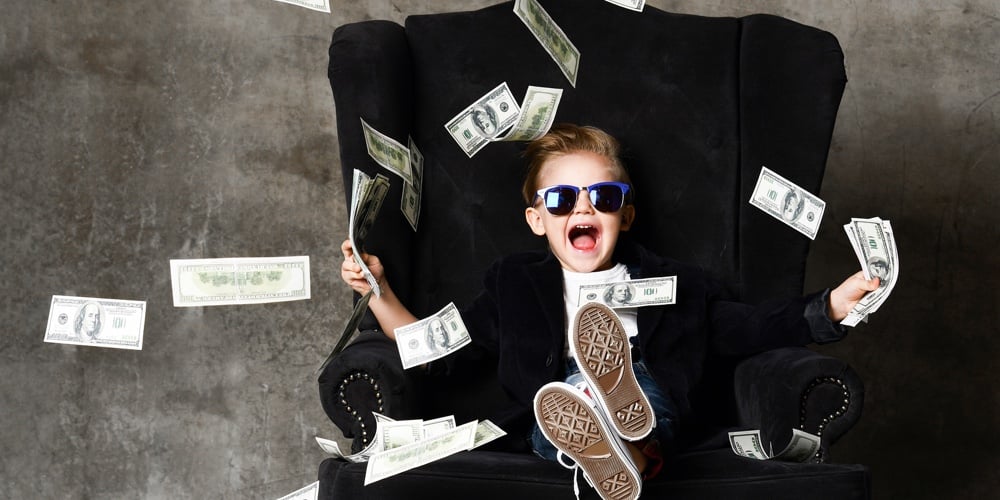 Happy Shouting Self-confident Rich Kid Boy Millionaire Sitting With Legs Crossed In Luxury Armchair