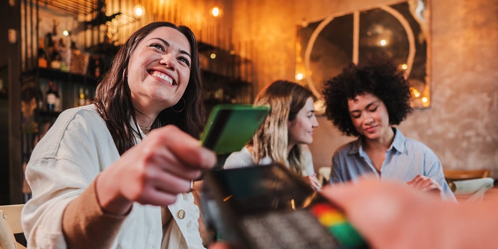 Picture1|Happy Young Woman Paying Bill With A Contactless Credit Card In A Restaurant. Female Smiling Holding