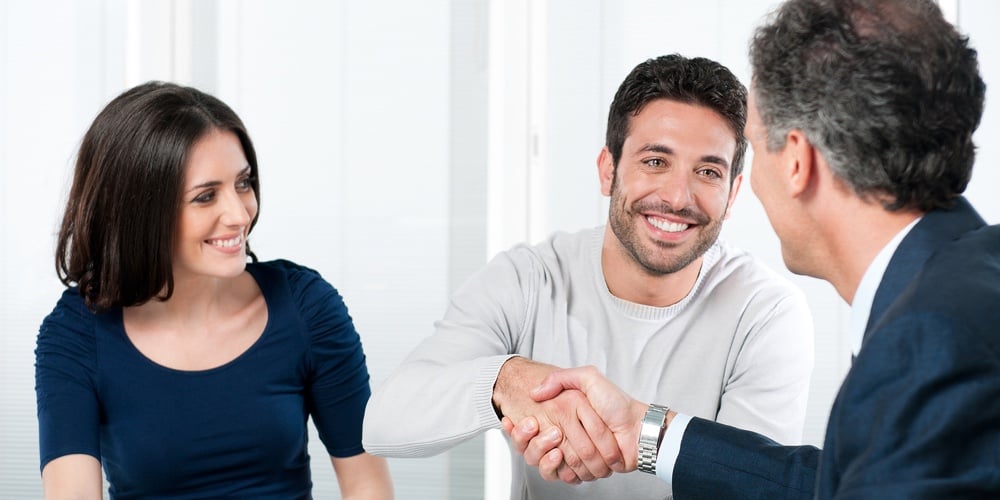 Happy couple seal a deal with their personal financial advisor at home|Medical advisor during home visit with senior couple. Financial insurance agent in conversation with|Mature smiling couple meeting financial advisor for investment at office. Financial consultant prese