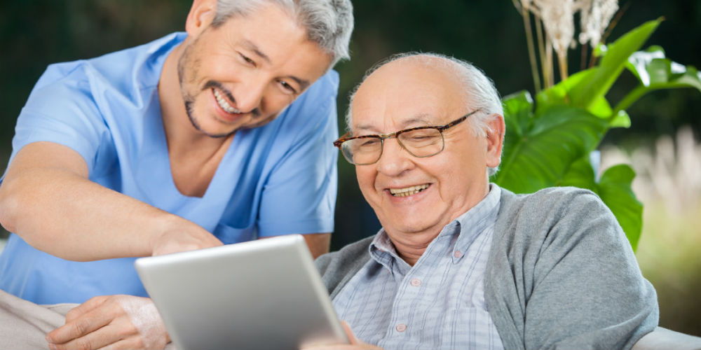 bigstock-Happy-male-nurse-and-senior-ma-79687192