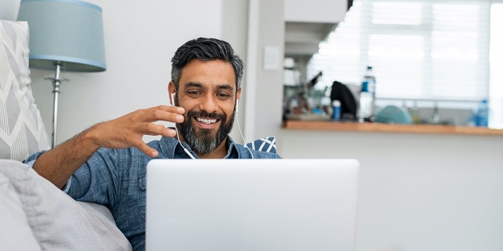 Group Of Business Professionals Having A Meeting. Diverse Group Of Designers Smiling At The Office.|Happy mature man relaxing on couch while video calling using laptop at home. Latin man sitting on so