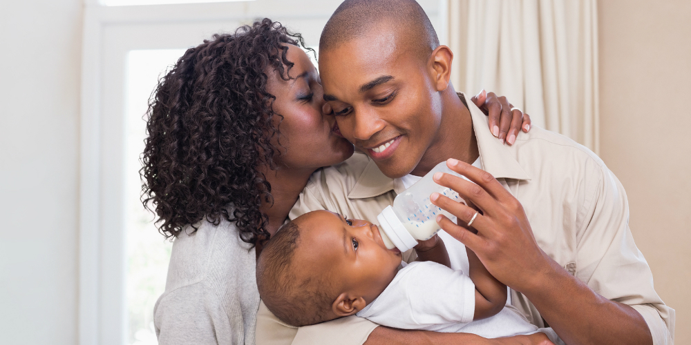 bigstock-Happy-parents-feeding-their-ba-68470369