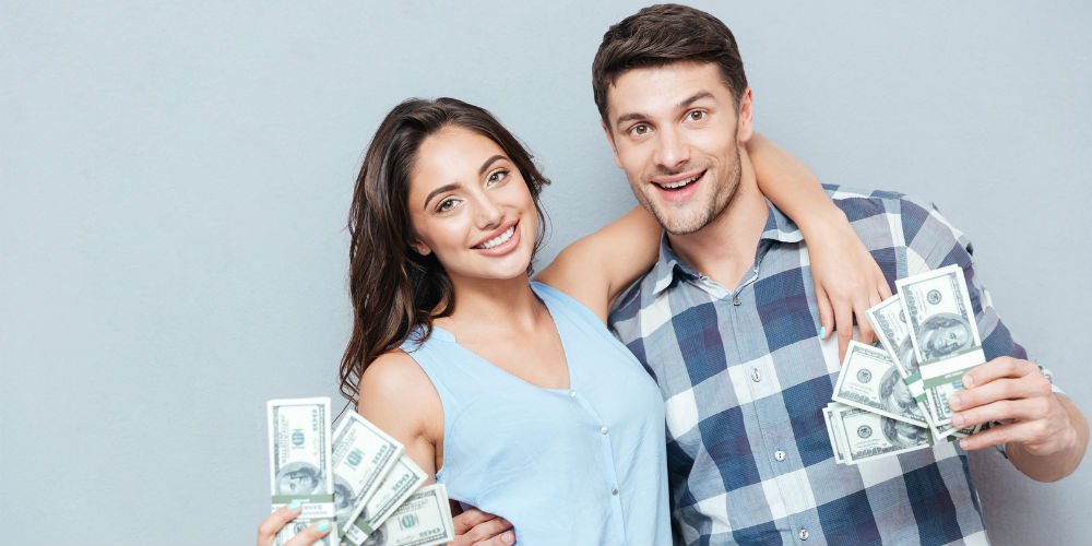 bigstock-Happy-young-couple-showing-the-133535078