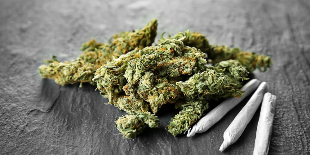 bigstock-Heap-of-weed-buds-and-cigarett-192142222