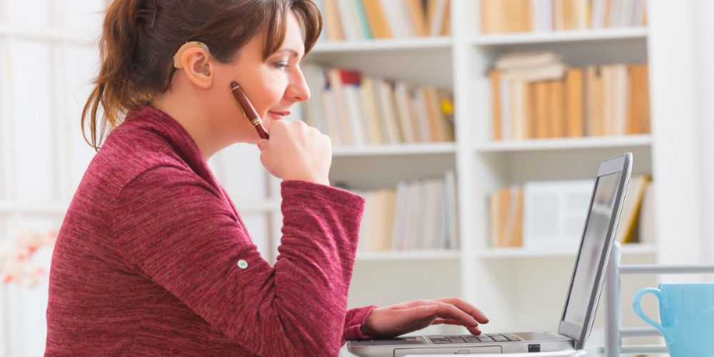 bigstock-Hearing-impaired-woman-working-118324697