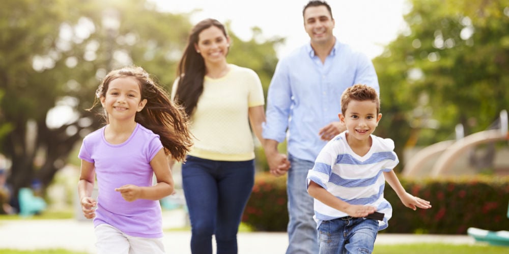 bigstock-Hispanic-Family-Walking-In-Par-94459580