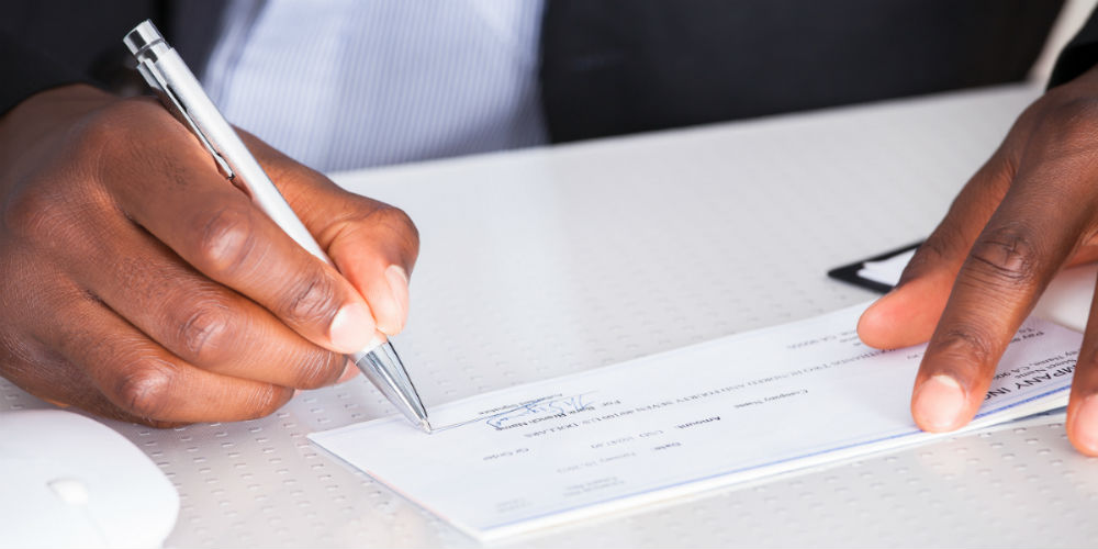 bigstock-Human-Hand-Writing-On-Cheque-65246050