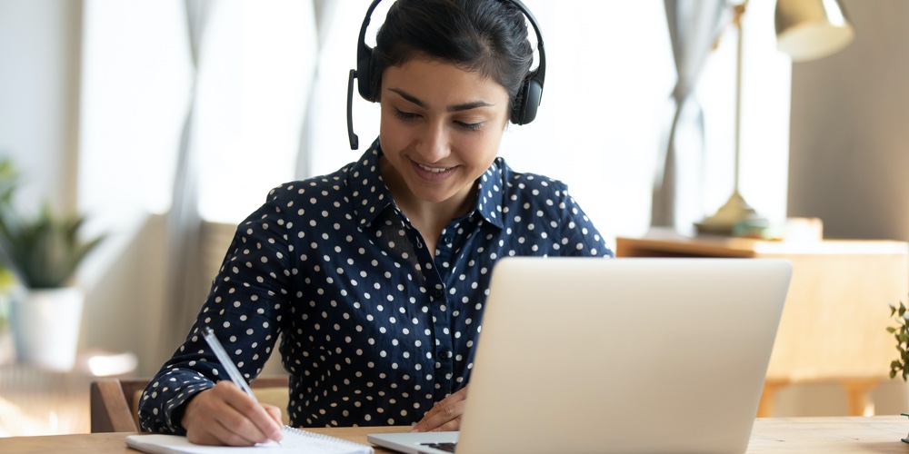 Indian Girl Student Wear Headset Study Online Teacher Write Notes