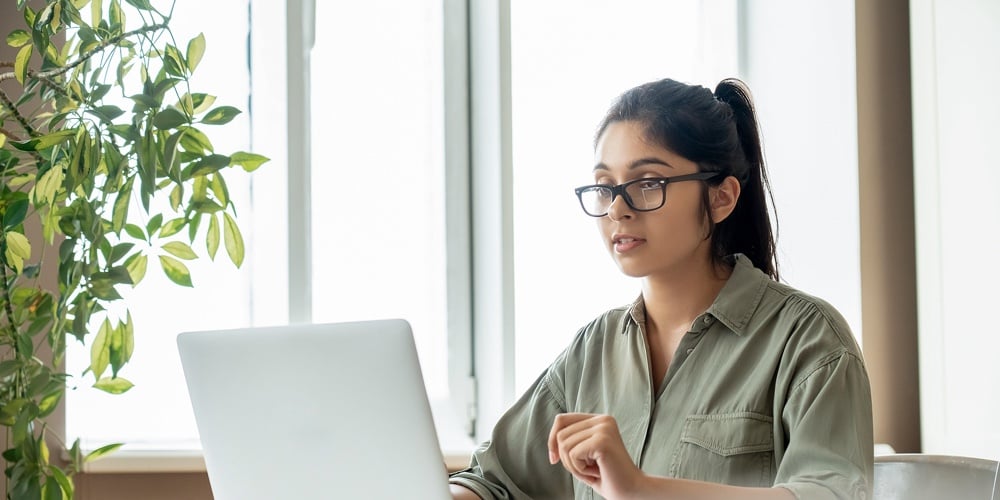 Indian Young Lady Teacher Or Student Watching Online Education Video Workshop Webinar