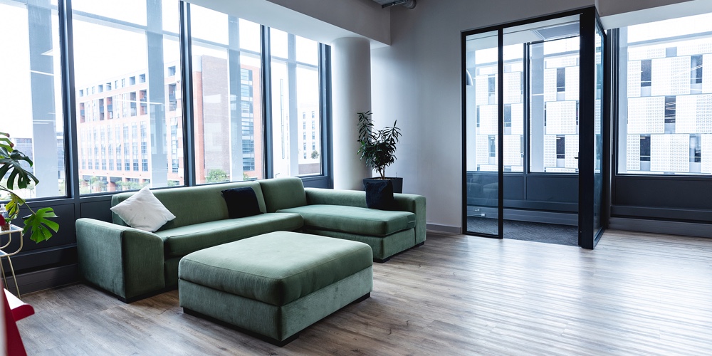 Interior of empty modern office with sofa and windows. modern office of a creative design business.