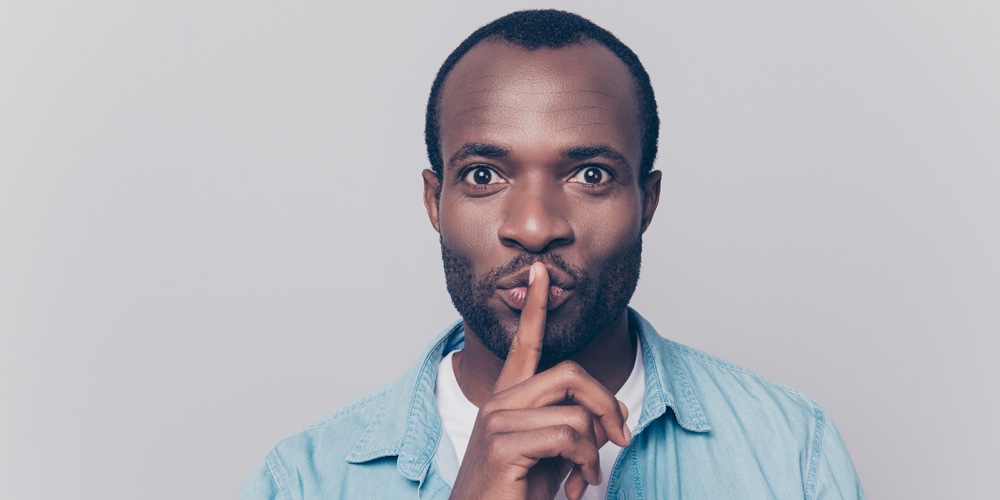 Just Don’t Speak! Close Up Portrait Of Handsome Cheerful Mysterious Silent Man Making Hush Gesture,