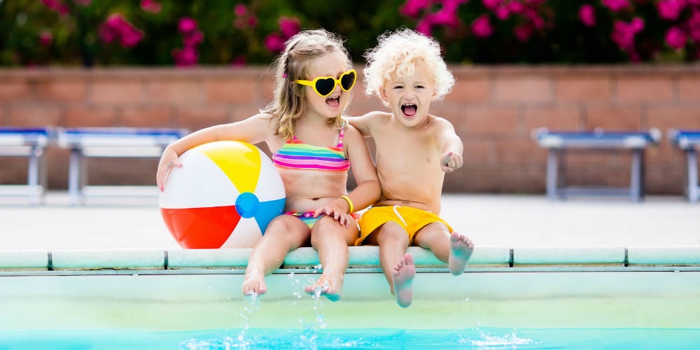 bigstock-Kids-Playing-At-Outdoor-Swimmi-182735080