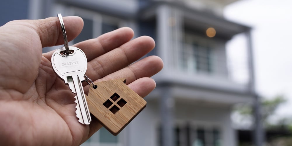 Landlord Unlocks The House Key For New Home.  Real Estate Agents