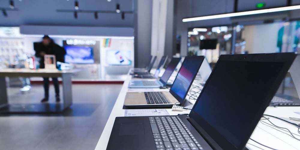 Laptops On The Table In The Electronics Store. The Department Of Laptops In The Tech Store. Buy A La