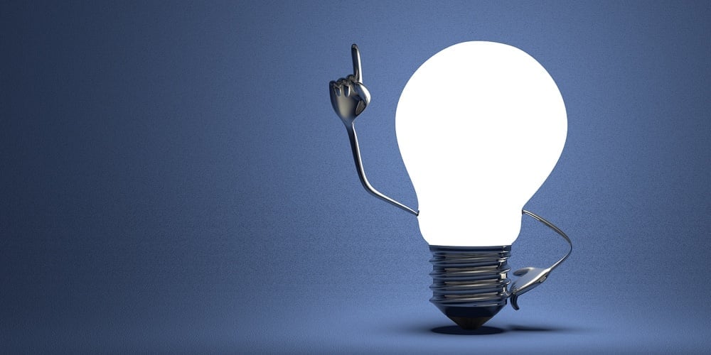 Light Bulb With Big Hands In Moment Of Insight On Blue