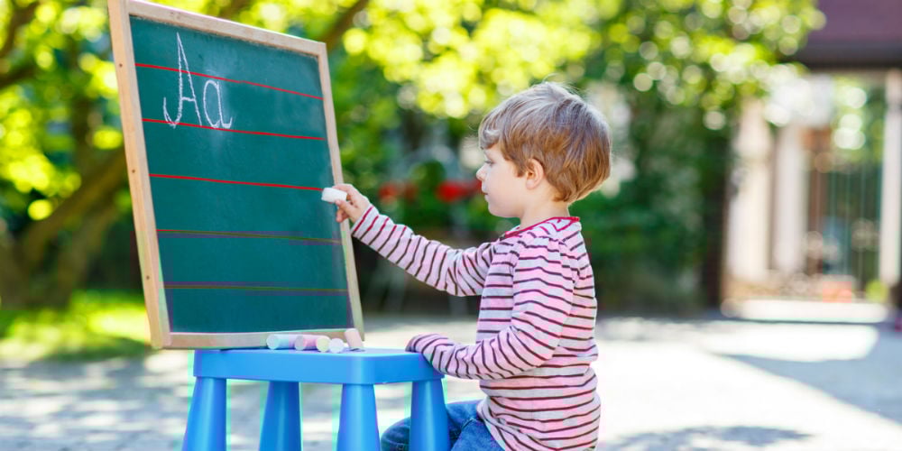 bigstock-Little-Boy-At-Blackboard-Learn-94968101