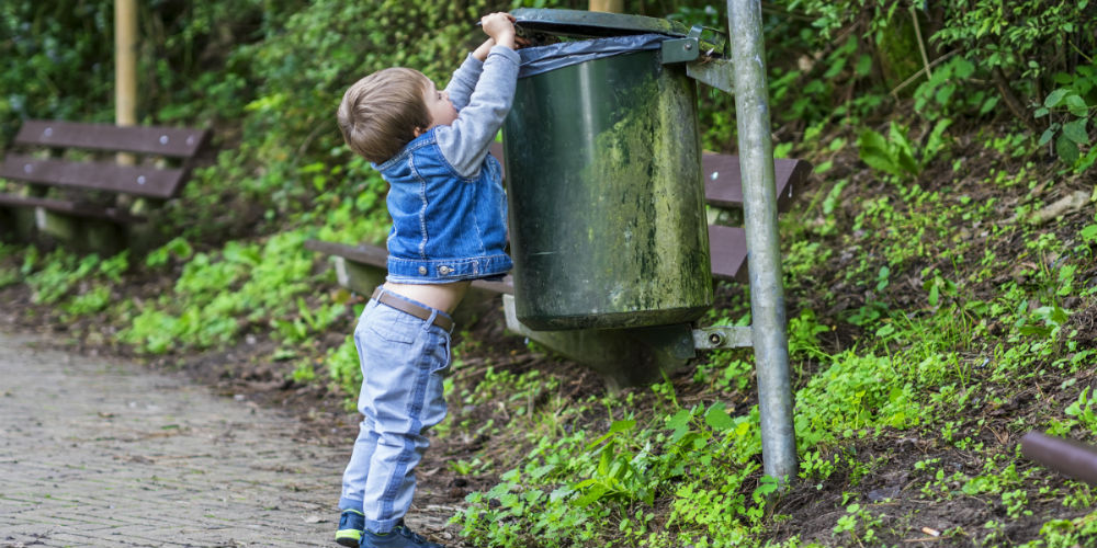 bigstock-Little-Boy-Throwing-Trash-In-T-103495397