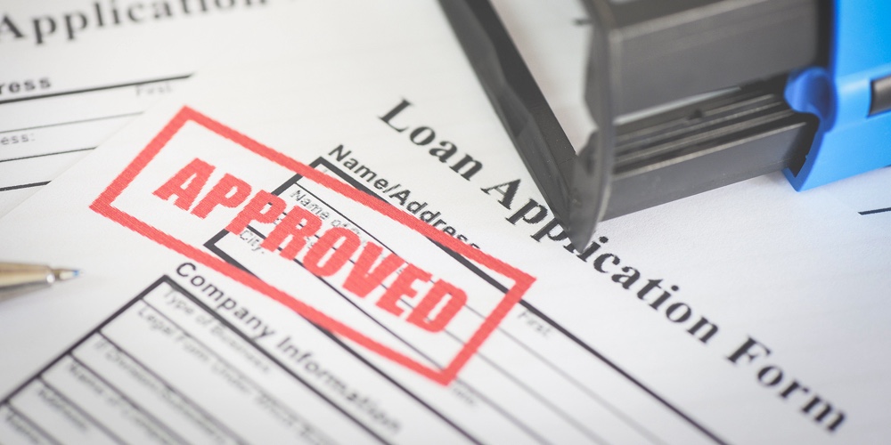 Loan Application Form With Rubber Stamping That Says Loan Approved