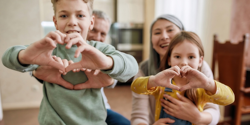 Love Your Family. Happy Grandparents With Grandchildren Making Heart Sign With Hands And Smiling At
