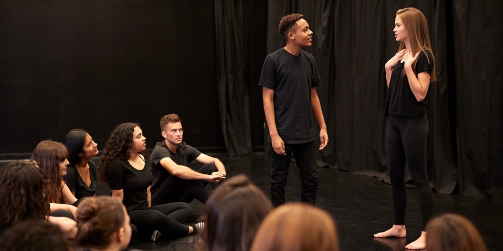 Male And Female Drama Students At Performing Arts School In Studio Improvisation Class