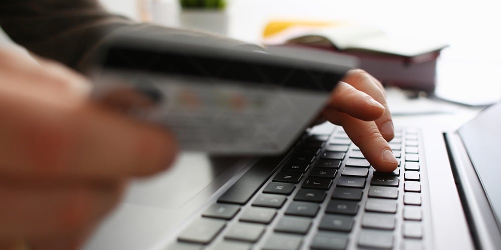 bigstock-Male-Arms-Hold-Credit-Card-Pre-265059913