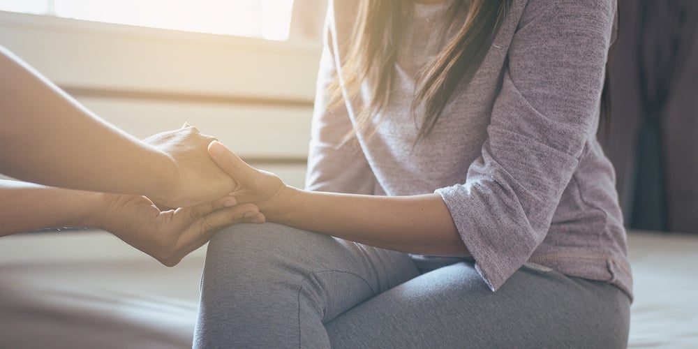 Man Giving Hand To Depressed Woman
