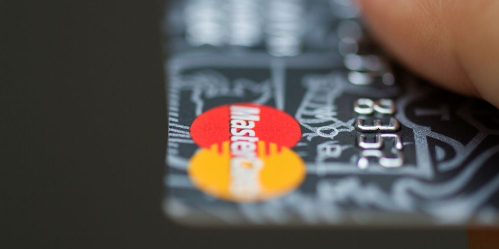 bigstock-Man-Holding-Mastercard-Bank-Cr-97283465