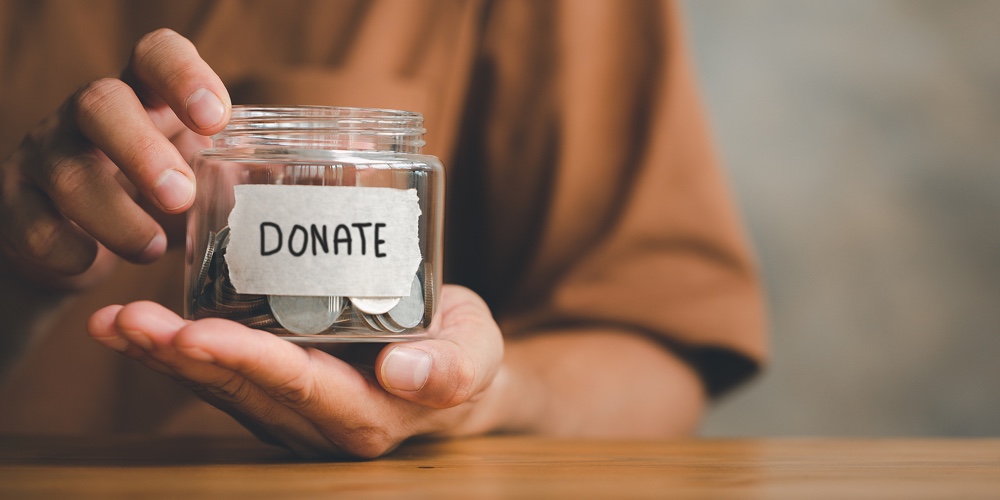Man Holding Money Jar With Donate Word Written Text Label For Giving And Donation Concept
