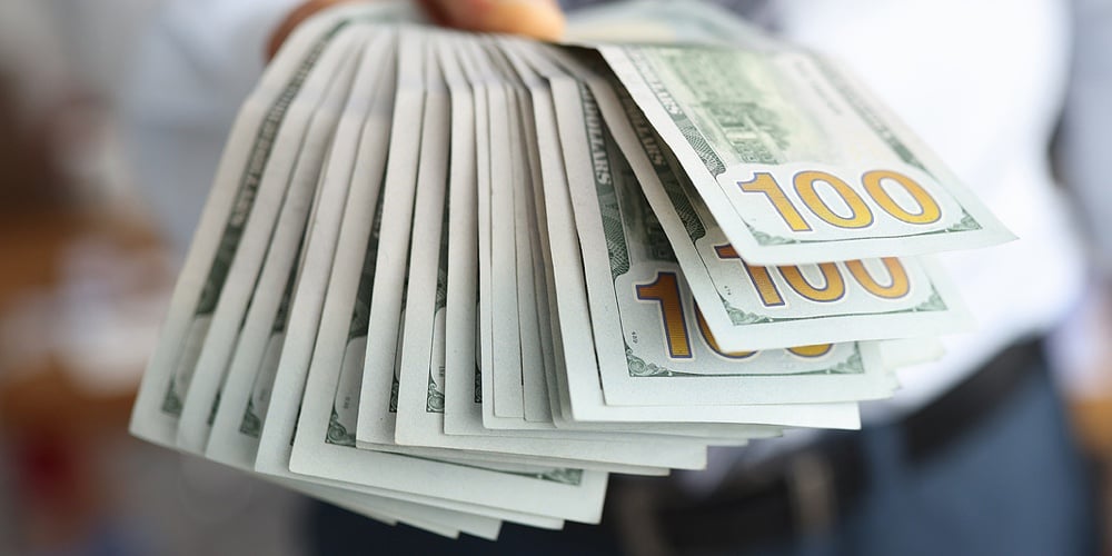 Man Holds In His Hand Fan Of One Hundred Dollar Banknote. Low Interest Lending To The Population Con