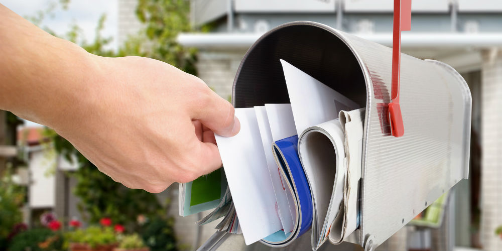 bigstock-Man-Taking-Letters-From-Mailbo-81965090