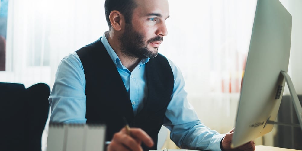 Man Thinking Looking In Monitor Computer At Home Workplace. Social Distance Bearded Businessman Work