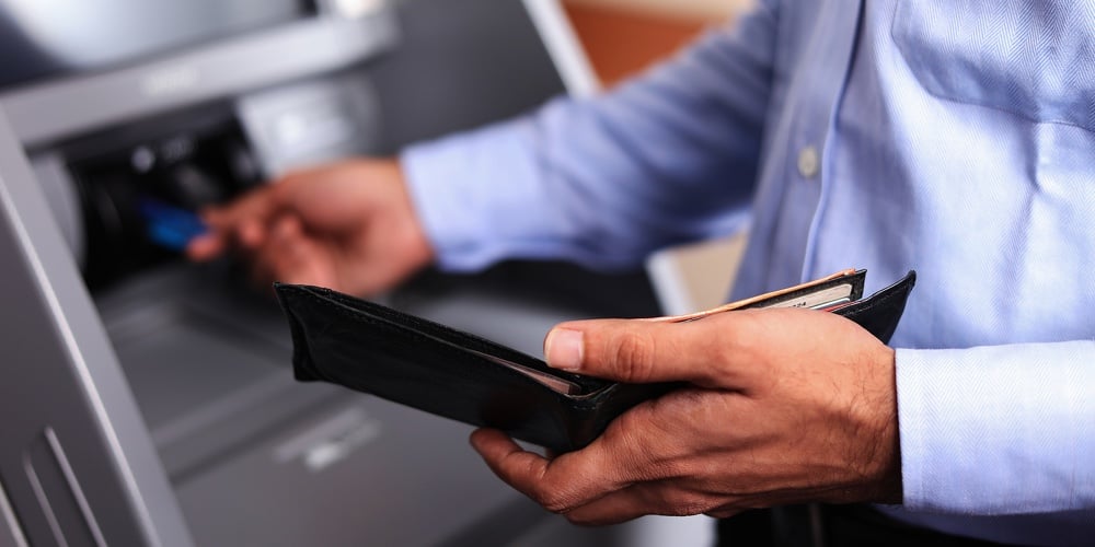 Man With An Open Black Wallet At Atm Machine
