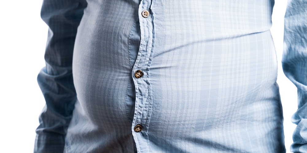 Man With Overweight. Symbolic Photo For Beer Belly. Weight Loss Concept. Tight Shirt.