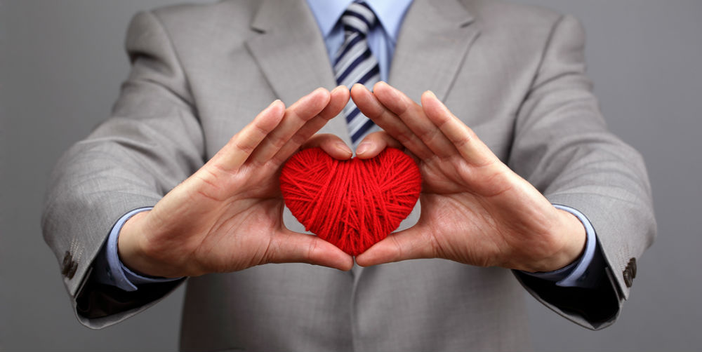 bigstock-Man-holding-a-red-woolen-heart-56186573