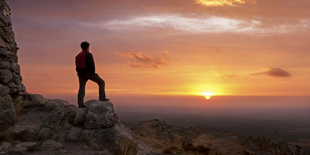 bigstock-Man-on-top-of-a-mountain-stand-51437401