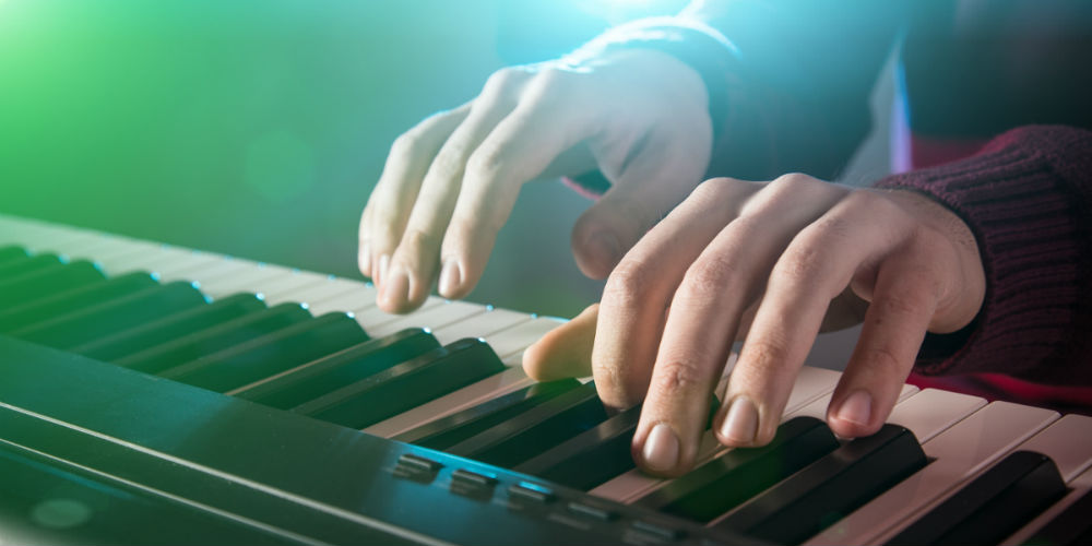 bigstock-Man-s-hand-playing-piano-111682835