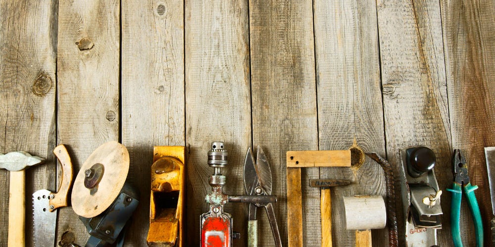 bigstock-Many-working-tools-on-a-wooden-85479323