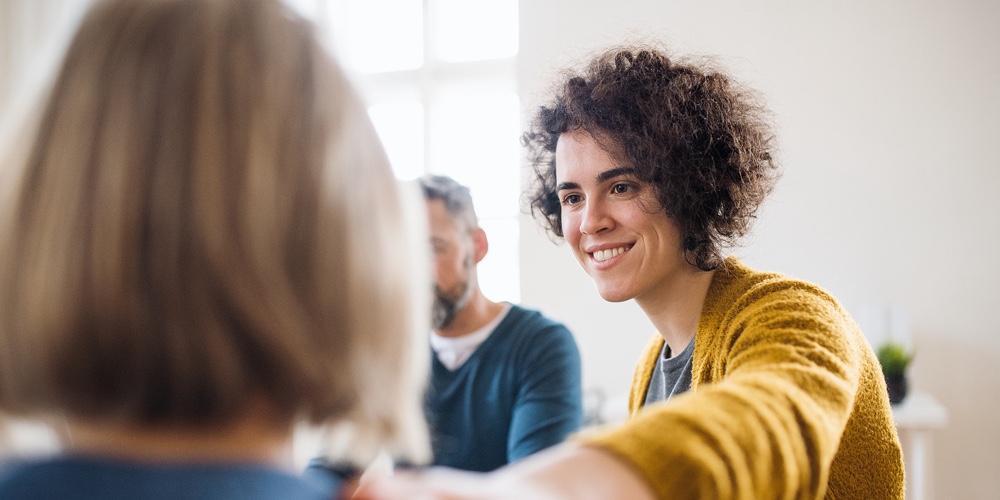 Men And Women Sitting In A Circle During Group Therapy
