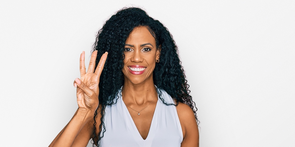Middle age african american woman wearing casual style with sleeveless shirt showing and pointing up