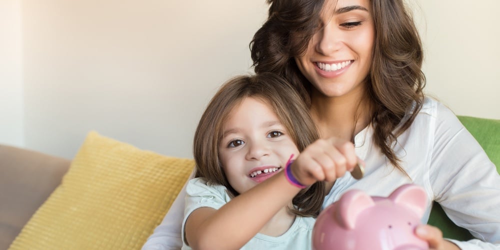 bigstock-Mom-And-Daughter-Saving-Money-109336913