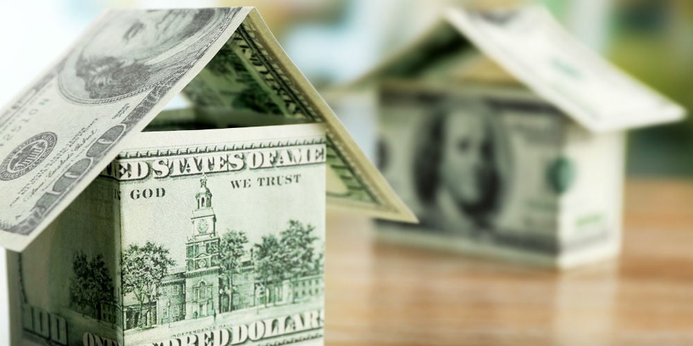 bigstock-Money-house-on-wooden-table-c-121913618