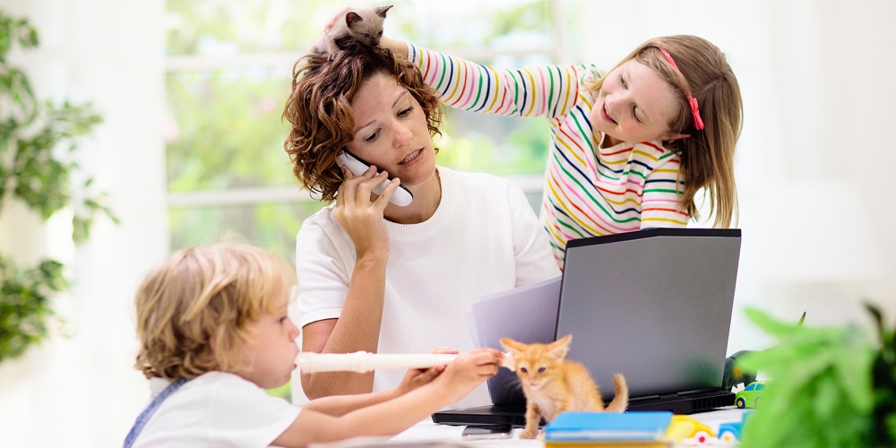 Mother Working From Home With Kids. Quarantine And Closed School During Coronavirus Outbreak. Childr